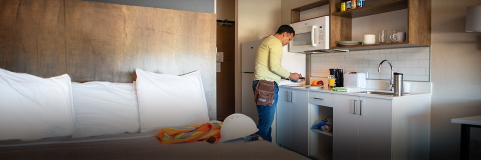 construction worker in hotel room making breakfast