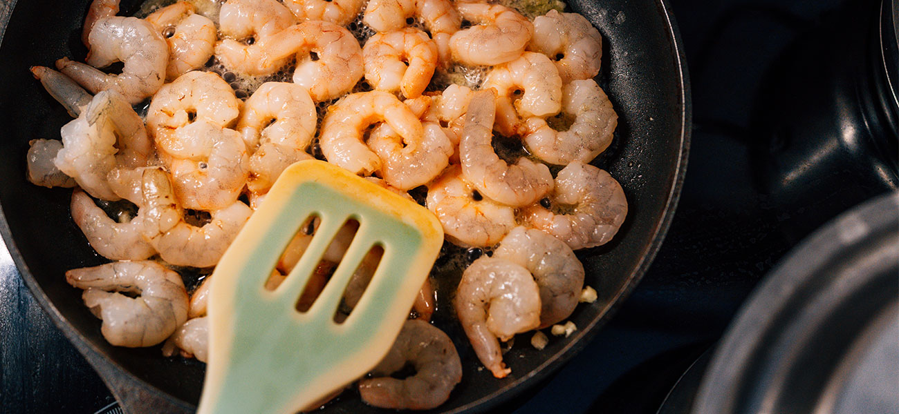 Shrimp cooking on skillet.