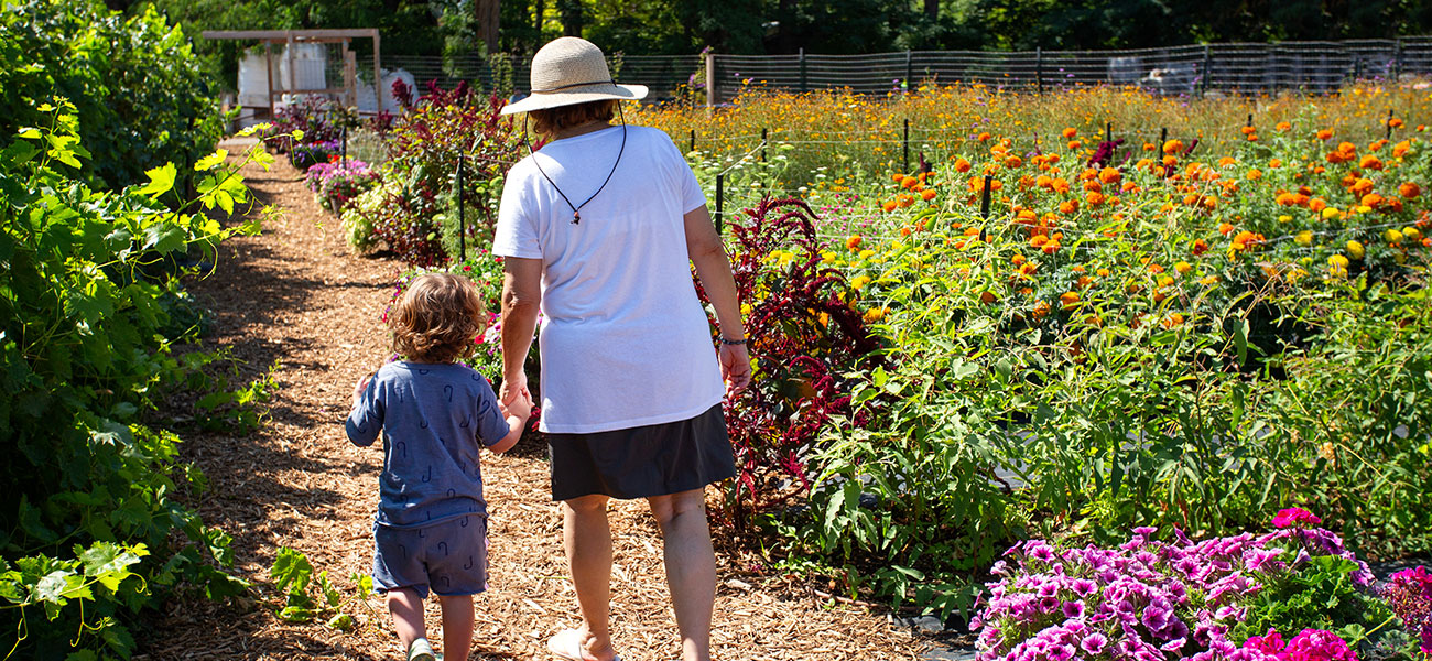 Grandma and grandchild walking in the Botanical Gardens.