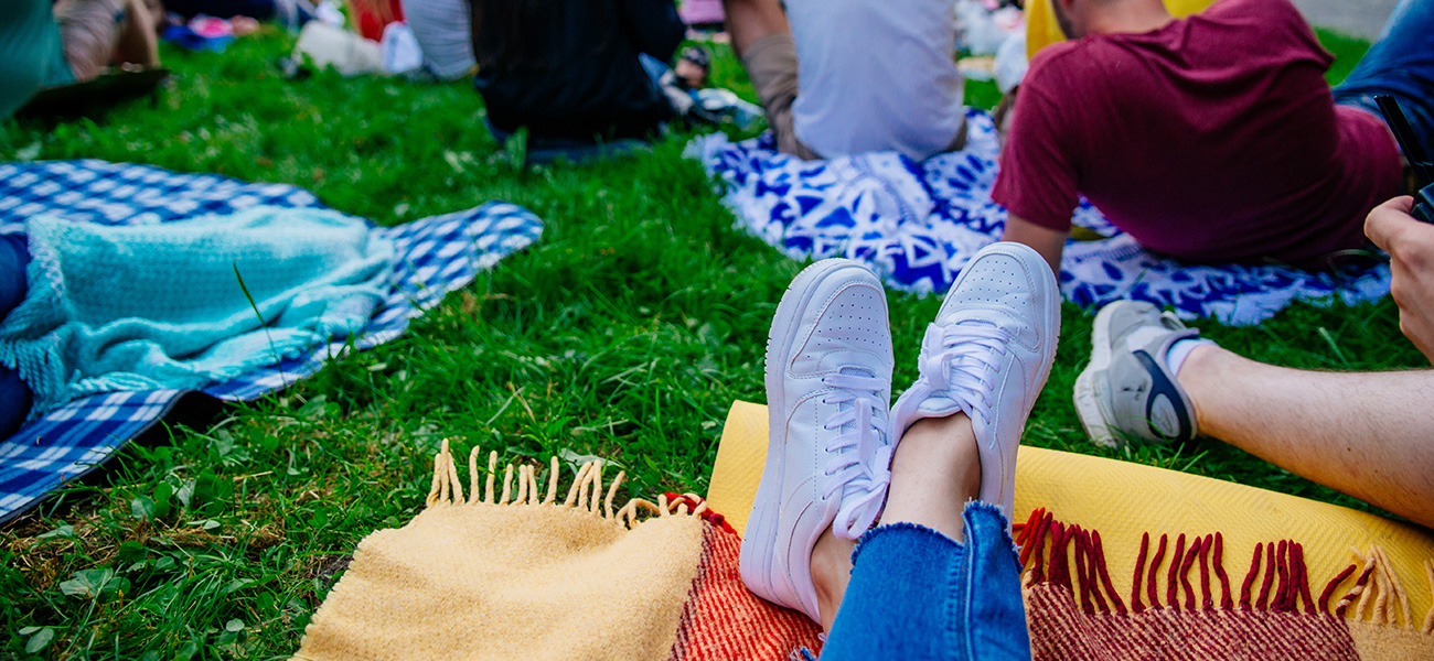 People on blankets in park at a movie night