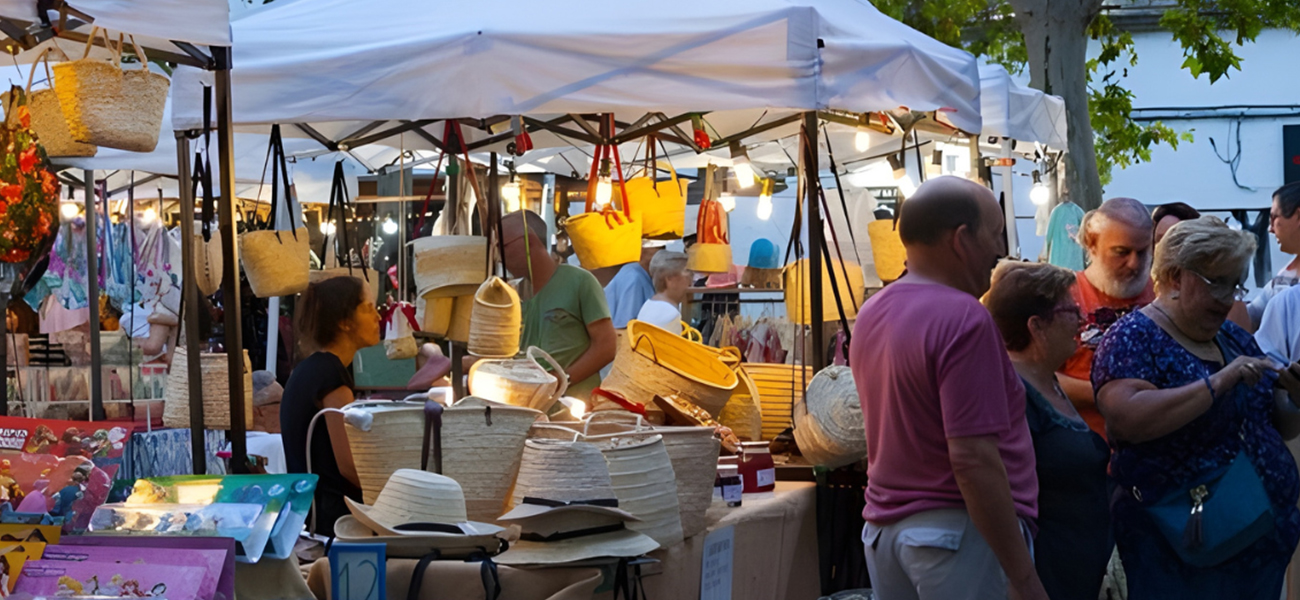 People enjoying an outdoor craft market