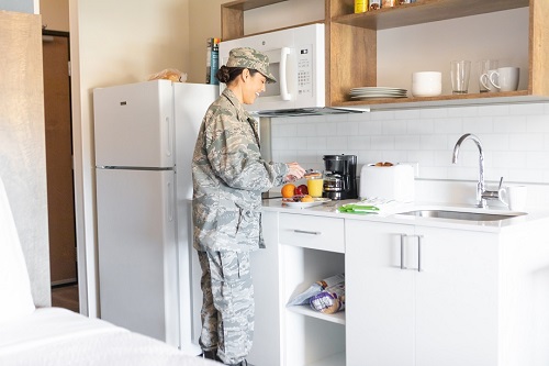 Military personnel preparing food in the kitchen