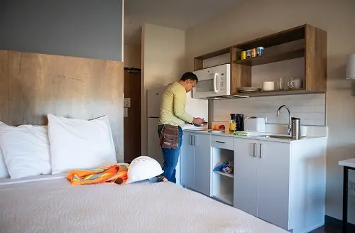 Construction worker preparing food in his suite